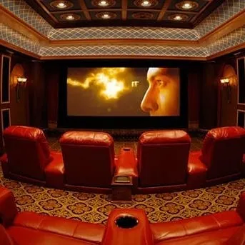 A luxurious home cinema featuring deep red leather recliners and an ornate coffered ceiling. The design focuses on classic elegance and acoustic precision, ensuring every seat offers an immersive audio-visual experience.