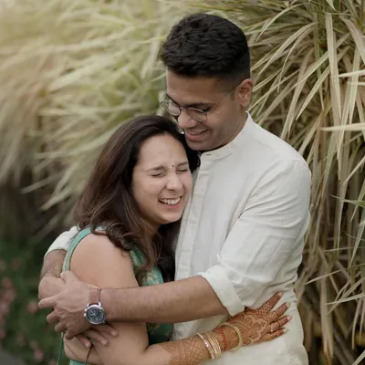 A warm, happy hug filled with genuine laughter. This is the kind of comfortable, easy love I aim to capture in my candid couple photography.