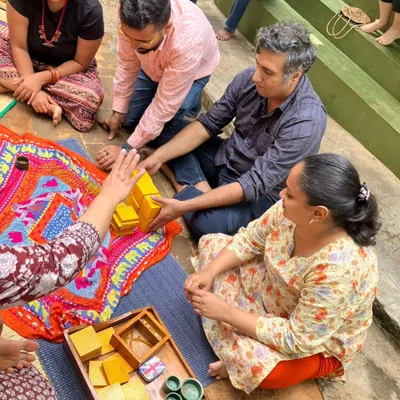 Parents work together with the Golden Bead material, which introduces the decimal system. This hands on experience demystifies how children learn complex mathematical concepts in a concrete, intuitive way.