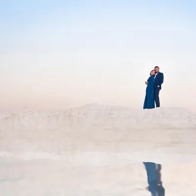 A moment of minimalist beauty at the salt plains near Jaipur. The couple stands against a vast, ethereal landscape, their reflection creating a perfect symmetry. This kind of shot shows how a simple location can create a powerfully artistic pre wedding portrait.