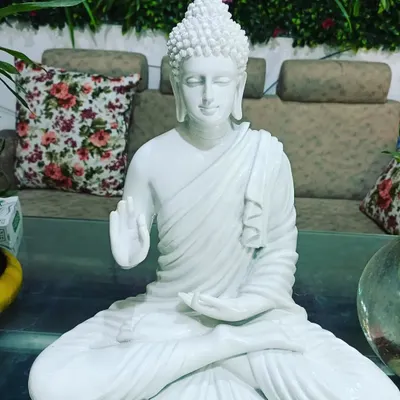 This medium-sized white marble Buddha statue is available for purchase. It's perfect for adding a touch of serenity to your home or garden.
