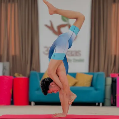 This is an advanced handstand variation, a pose that demands total body control and focus. With consistent practice, you can become unstoppable.