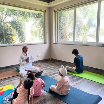I love this moment of connection and play during a kids' yoga class. While I guide the session, children are free to explore movements in their own way, fostering a positive relationship with their bodies.
