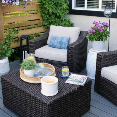 This outdoor furniture set is perfect for creating a cozy balcony or patio retreat. The all-weather wicker armchairs and matching coffee table are both durable and stylish, while the plush, light-colored cushions ensure comfort for relaxing outdoors.