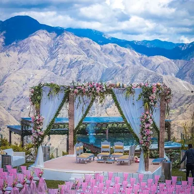 A spectacular wedding mandap set against a majestic mountain range. We specialize in creating these harmonious blends of natural beauty and elegant design for destination weddings.