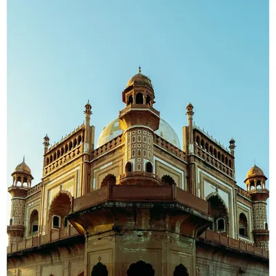The magnificent facade of Safdarjung's Tomb, captured in the warm light of the golden hour. The sandstone and marble structure is a testament to the last phase of Mughal architecture in Delhi.