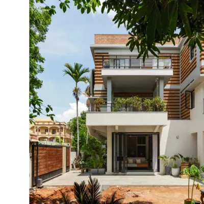 The renovated and extended residence for Sunith and Shruti in Hyderabad. The new facade features a striated pattern of alternating brick courses, a design choice that was both an aesthetic decision and a practical solution to material shortages during the pandemic.