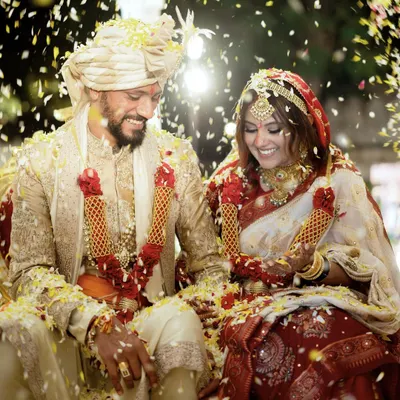 The moment of pure joy and celebration, showered in petals. This candid shot of Urjaa and Tejas captures the happiness of finally being married, surrounded by love and laughter.