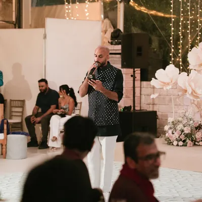 On the mic during a Sangeet night in Lisbon. Hosting and engaging with the crowd is a huge part of what I do. It's about creating a fun, interactive atmosphere for everyone.