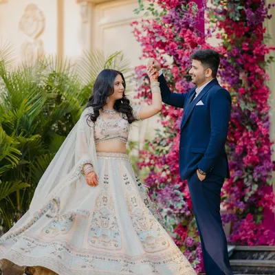 A fairytale moment from a ring ceremony, as the couple shares a dance against a stunning wall of pink and purple flowers. This is a perfect shot for a grand and beautiful engagement.