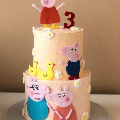 A cheerful two-tiered cake for a Peppa Pig fan. This design features the whole family, handcrafted and placed on a lovely pastel cake with little flowers.