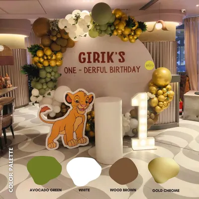 For Girik's "one-derful" first birthday, I chose a sophisticated jungle theme palette of avocado green, wood brown, and gold chrome. The result was an elegant yet playful Lion King adventure.