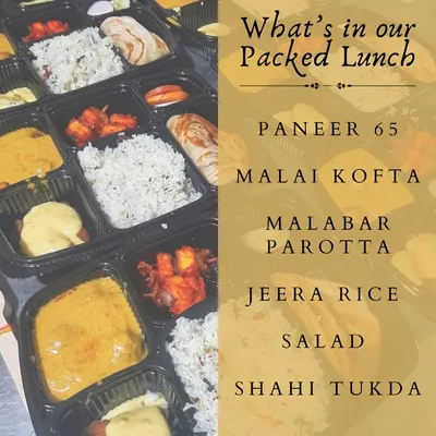 A look inside our packed vegetarian lunch box. This meal includes Paneer 65, Malai Kofta, Malabar Parotta, Jeera Rice, Salad, and a delicious Shahi Tukda for dessert.