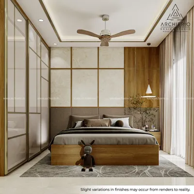 This master bedroom is a study in texture and warmth. The design combines a fabric headboard, wallpaper, veneer beading, and brushed gold accents to create a layered and luxurious feel.