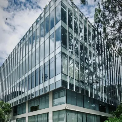 Where architecture meets light and reflection. The JJJ Commercial building is a sleek testament to modern minimalism, with a glass facade that invites the outdoors in.