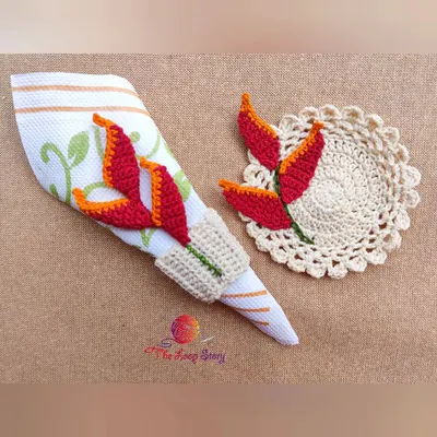 A closer look at the custom-designed crochet coaster and napkin ring set, inspired by the heliconia flower.