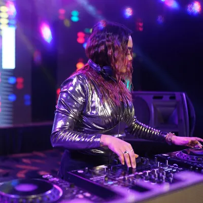 A focused shot of me at the decks, surrounded by colorful lights. This is my office.