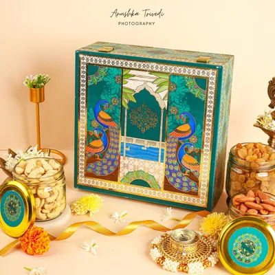 This peacock-themed Diwali hamper was a dream to style. I used rich teal and gold tones with traditional diyas and marigolds to create a scene that feels both royal and festive.