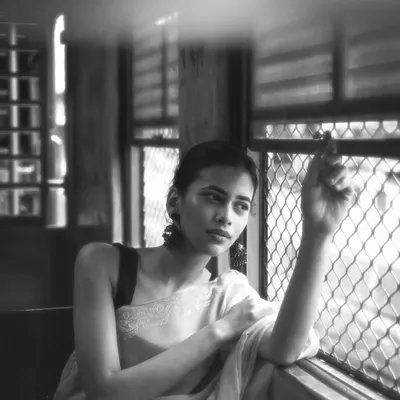 A moment of thought by the window of a Mumbai local. The unique light and movement inside the train create a perfect setting for introspective and cinematic portraits.