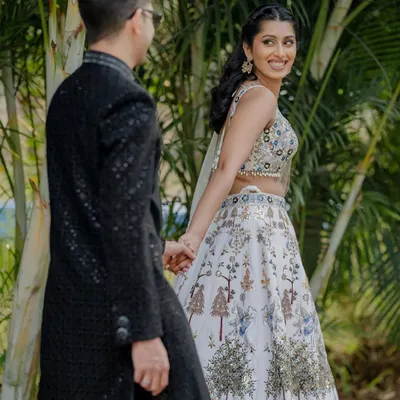 A candid moment from a cocktail celebration. The bride's joyful glance back at her partner captures the happiness of the occasion, with our venue's trees providing a natural frame.