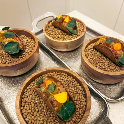 My canapé-sized mushroom tacos. These bite-sized treats are filled with fermented garlic aioli, green papaya som tam, and a truffle egg yolk gel.