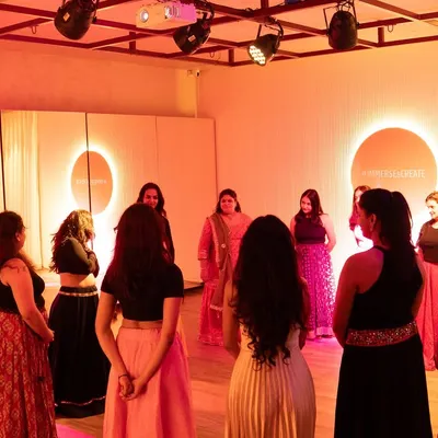 Participants gathered in a circle at The Immersion Room, a workshop focused on embodied expression for women. This setup fosters a strong sense of unity and shared experience during our movement therapy sessions.