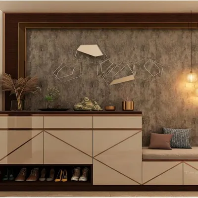 A stylish foyer unit with a built-in cushioned seat. The cabinet features a glossy finish with geometric gold inlay and an open shelf at the bottom for frequently used shoes.