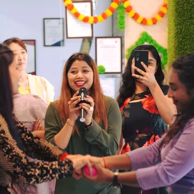 Our founder, Nazia Khanam, leads a fun activity during our Onam celebration. We foster an environment where everyone feels included and joyful.