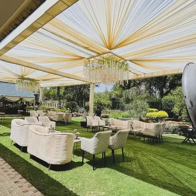 We transform open spaces into elegant venues for corporate gatherings. This daytime event at a Chhatarpur farmhouse features a sophisticated lounge setup under a draped canopy with crystal chandeliers, perfect for executive retreats or client appreciation parties.