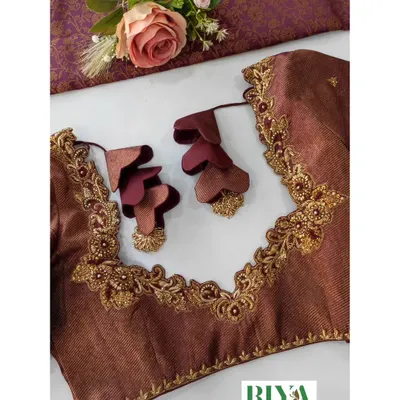 This blouse is all about unique details. I used a rich brown fabric and created an intricate neckline with Zardosi work. The standout feature is the custom tassels, made from layered, petal shaped fabric pieces that add a beautiful, three dimensional touch.