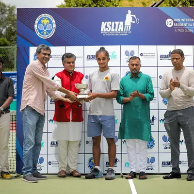 Sehaj receiving his ITF J30 Singles Winner's trophy in Bengaluru. This victory at a KSLTA-hosted international event highlights his dominance on home soil.