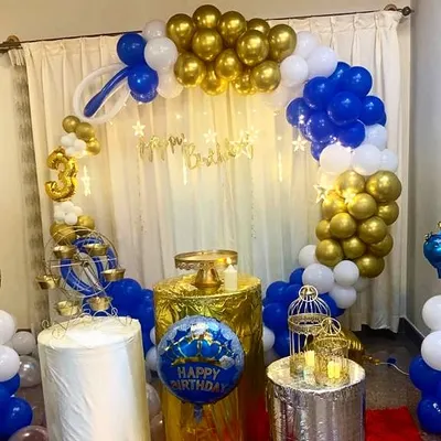 A full view of a birthday party setup we did at a client's home. The circular balloon arch in royal blue, gold, and white, combined with fairy lights, created a festive and grand look for the celebration.
