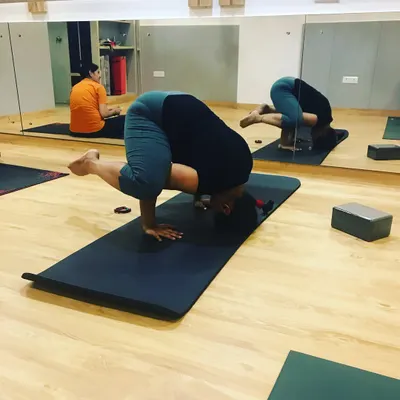 Witnessing a student's progress is one of the greatest joys of teaching. Here, a student is courageously working on her tripod headstand, building the core strength and confidence needed for inversions.