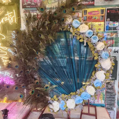 This is one of my signature Ganapati decoration frames, featuring a stunning arrangement of real peacock feathers and artificial flowers. It’s a unique and elegant backdrop that brings a divine touch to your festival celebrations at home.