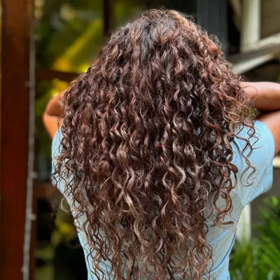 A stunning example of grey blending on long, beautiful curls. The highlights and natural greys work together seamlessly.
