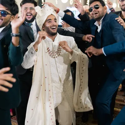 The groom's electrifying entrance to the Sangeet, surrounded by his best friends. We capture the energy and excitement of the dance floor.