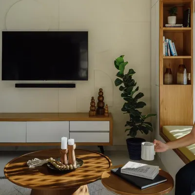 This living room features a set of nesting coffee tables I built. The solid wood tops and pedestal bases provide a modern yet organic feel. They are paired with a simple, low-profile TV console.