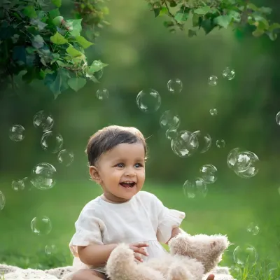 The magic of bubbles. An outdoor session is perfect for capturing a baby's wonder and excitement as they interact with the world around them.