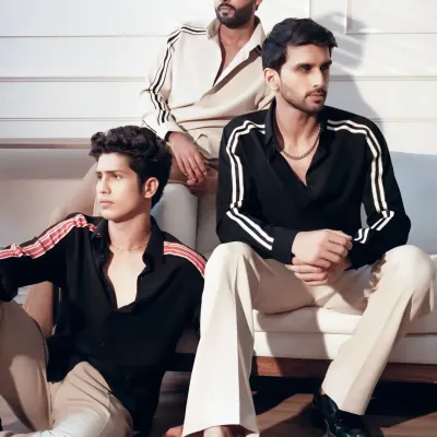 Sharp, simple, and always on point. This collection of minimal shirts with striped sleeve details and tailored trousers is designed for the modern man's wardrobe.