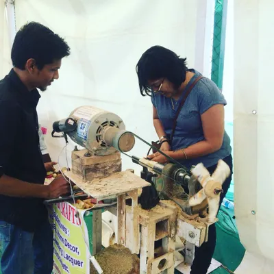 Here, one of our artisans provides one-on-one guidance to a visitor at the lathe. We ensure everyone feels comfortable and confident as they learn the basics of wood turning, making the experience accessible even for complete beginners.