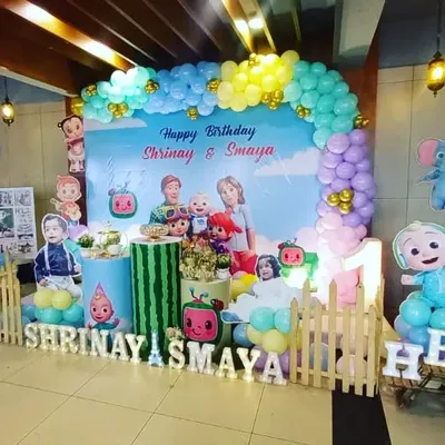 A colorful and fun Cocomelon theme for twins Shrinay and Samaya's first birthday. We created a vibrant backdrop with all their favorite characters, a balloon arch, and custom name signs for a picture-perfect celebration.