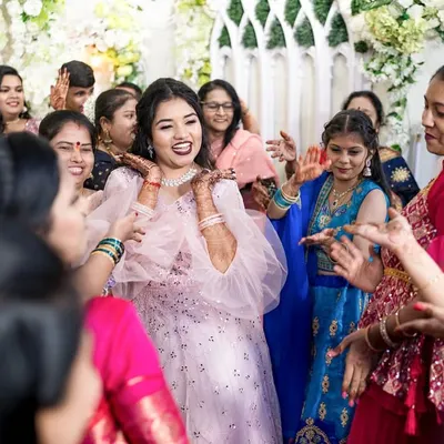 A wedding is a whirlwind of energy and emotion. We position ourselves to capture the unscripted joy, like this moment of the bride being surrounded by the infectious happiness of her friends and family on the dance floor.