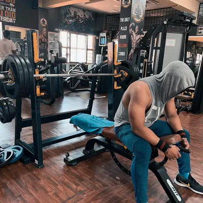 Discipline will take you to places motivation can't. This is a moment of rest and focus before the next heavy set on the bench press. The real battle is won in your mind before you even lift the weight.