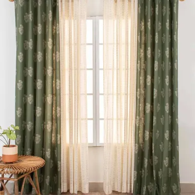 Our Malabar print curtain in a deep green is paired with a Dew Sheer curtain. This best-selling combination offers a rich, earthy look while the sheer layer keeps the space from feeling too dark.