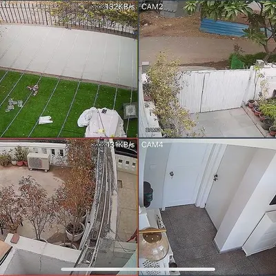 This is a four-camera view from a CP Plus HD system I installed at a home in DLF Phase-I, Gurgaon. It covers the front lawn, driveway, back patio, and an interior hallway, ensuring all key areas of the property are monitored.