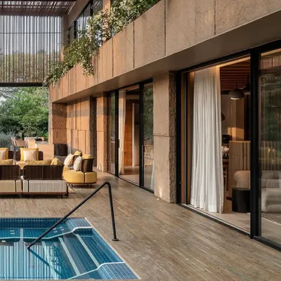 The poolside terrace at K House provides a seamless connection to the indoors. We used warm wood decking and planters with flowering bougainvillea to create a luxurious, resort-like atmosphere for lounging and swimming.