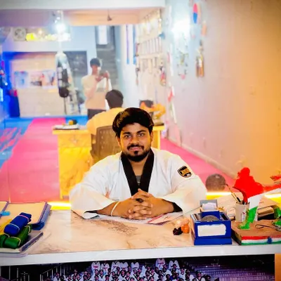 At my desk in the Aarav Taekwondo Academy. This is where I plan the training that will shape the future champions of India.
