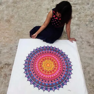Here I am with a huge, custom-painted mandala on canvas. I love working on a large scale to create a truly immersive piece of art that becomes the centerpiece of any room.
