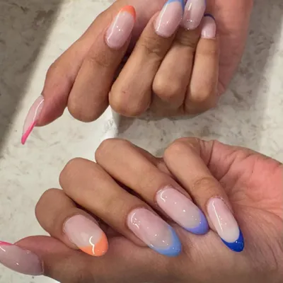 Why choose one color when you can have a rainbow? These trendy, colorful French tips on long almond nails are glossy, eye-catching, and so much fun.