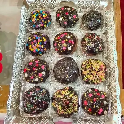 These are my sprinkle-covered chocolate rounds, made fresh at home. They are a fun treat for birthdays and kids' parties, or just to add a pop of color to an assorted chocolate box.